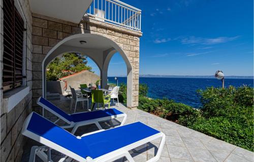 a patio with a table and chairs and the ocean at Holiday Home Prigradica Bb Cr in Prigradica