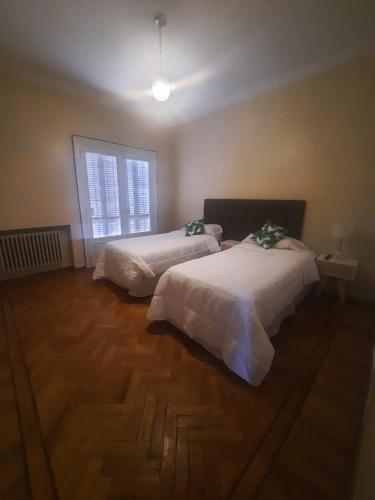 a bedroom with two beds and a window at 816 B&B in Mendoza