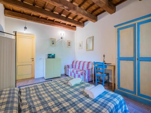 a bedroom with a bed and a couch and a table at Holiday Home in Sellano with Pool & Sun Terrace in Sellano