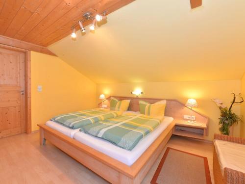 a bedroom with a large bed and a desk at Ruhiges Ferienhaus in Drachselsried in Waldnähe in Drachselsried