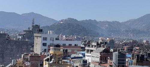 a city with buildings and mountains in the background at Hotel Nepalaya in Kathmandu
