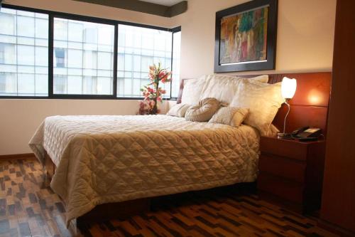 a bedroom with a large bed and a window at Host, Apartment for rent in Lima