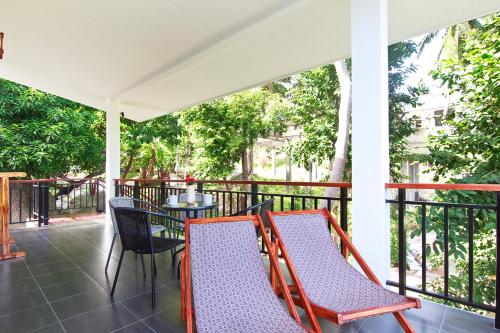 a porch with two chairs and a table at 2 Bays Villa in Thong Nai Pan Yai