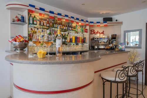 a bar in a restaurant with glasses on the counter at Hôtel Le Méditerranée in Hyères