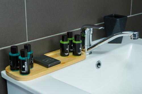 a bathroom sink with a shelf with bottles on it at מול ההר in Ein Zivan