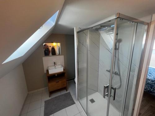 a bathroom with a glass shower and a sink at La villa Noukey à 150m de la plage et des cabines in Gouville-sur-Mer
