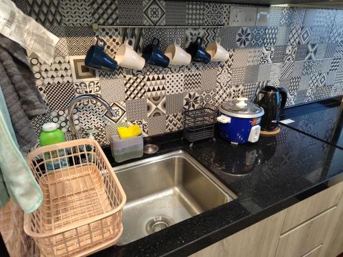 a kitchen sink with a basket next to it at D'A4 Homestay @ Vista Bangi in Kajang