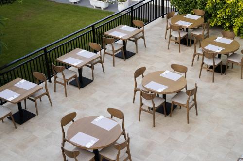 a row of tables and chairs on a patio at Hotel Malia Holidays in Malia
