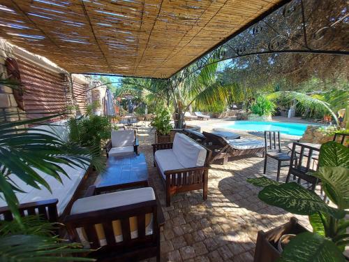a patio with a table and chairs and a pool at La Bella Donna in Ifaty