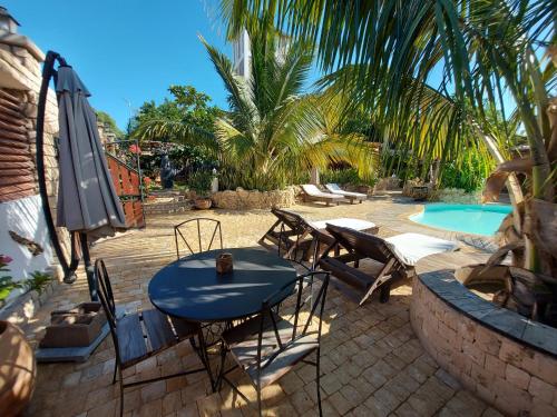 a patio with a table and chairs and a pool at La Bella Donna in Ifaty