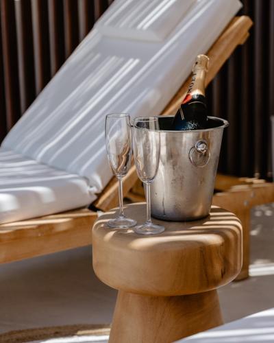 a bucket with a bottle of champagne and two glasses at Palm Beach Hotel Apartments in Rethymno Town