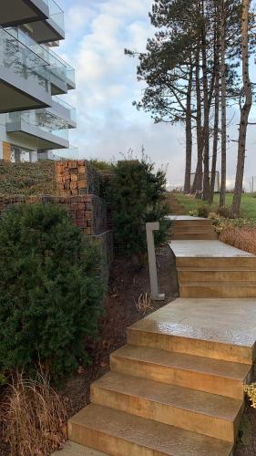 a set of stairs in front of a building at Apartament Przy Plaży Arka , z widokiem na Morze :) in Mielno