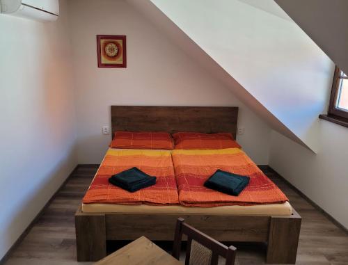 a bedroom with a bed with two pillows on it at Penzion a wellness U Třeboňské madony in Třeboň