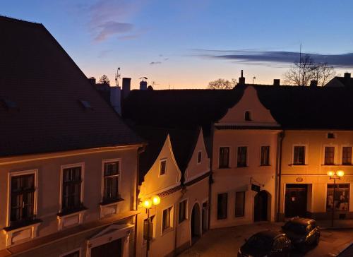 a view of a city with buildings at dusk at Penzion a wellness U Třeboňské madony in Třeboň