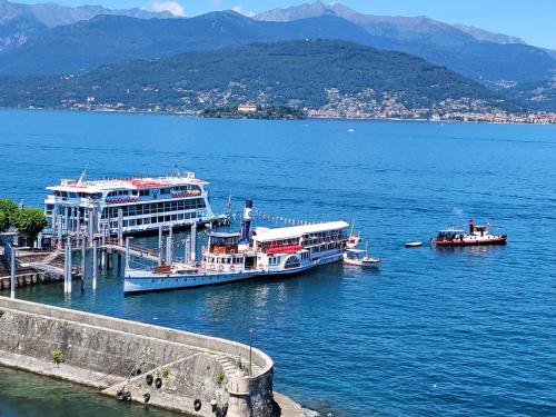 two boats are docked at a dock in the water at Sempione Boutique Hotel in Stresa