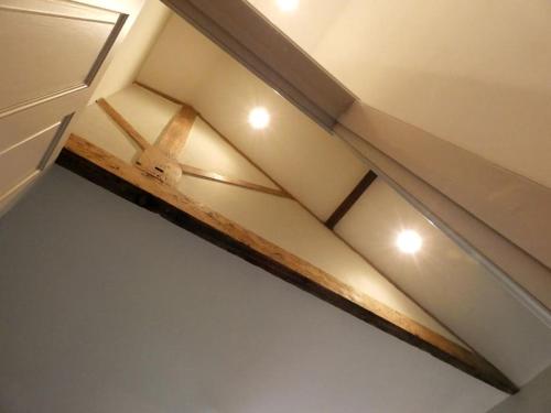 a ceiling with a wooden beam on a room at Y Cwtsh in Llandeilo