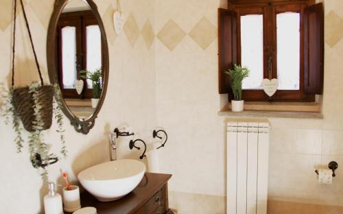 a bathroom with a sink and a mirror at aCasetta GuestHouse in Viterbo