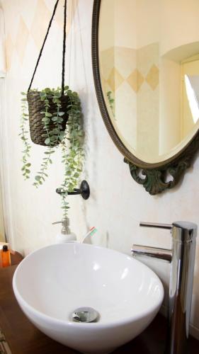 a bathroom with a white sink and a mirror at aCasetta GuestHouse in Viterbo
