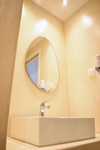 a bathroom with a sink and a mirror at Tzamaros Studios in Mérikhas