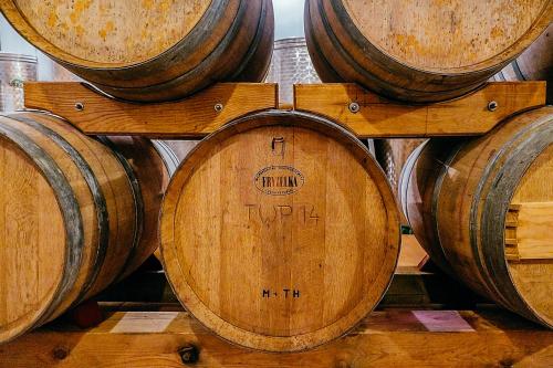 a pile of wooden barrels in a room at Restaurace-Pension-Vinařství U Šťastných in Mistřín