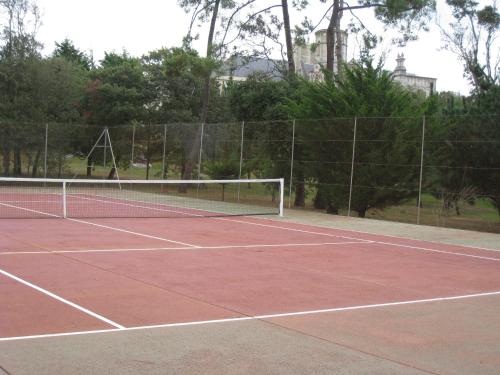 a tennis court with a net on top of it at Hôtel Primavera in Saint-Palais-sur-Mer