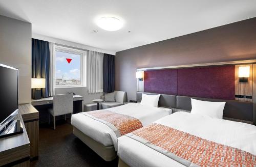 Ένα ή περισσότερα κρεβάτια σε δωμάτιο στο Daiwa Roynet Hotel Sapporo-Susukino