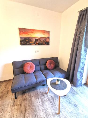 a living room with a couch and a table at Ferienwohnung Kramerhof in Ebbs