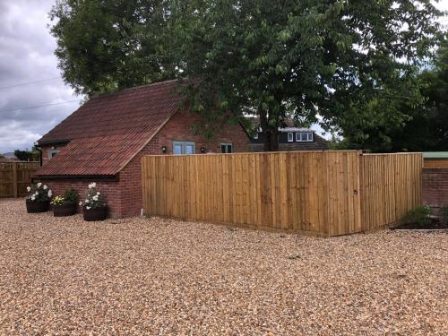 a wooden fence in front of a house at The Lodge in North Bradley