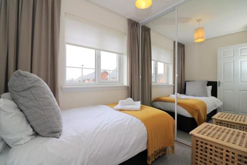 a hotel room with two beds and a window at Signature - Morrison House in Glasgow