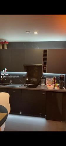 a kitchen with a stove and a counter top at LES SECRETS ROOMS, LOVE ROOM DE LUXE AVEC JACUZZI in Rivesaltes