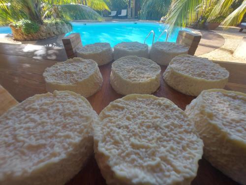 a group of breads on a table next to a pool at La Bella Donna in Ifaty