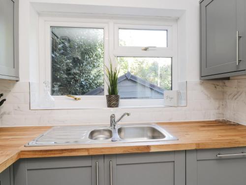 a kitchen counter with a sink and a window at Woodend in Saltburn-by-the-Sea