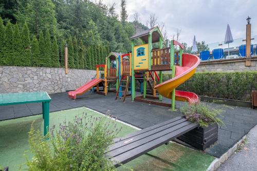 a playground with a slide in a backyard at Park Hotel Asenevtsi in Veliko Tŭrnovo