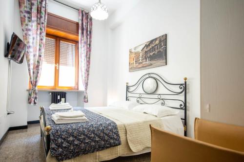a bedroom with a large bed and a window at Residenza Bra Apartment in Verona