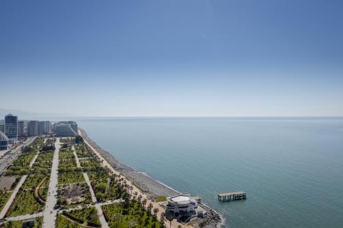 an aerial view of a beach with a boat in the water at The SPOT apartments - Orbi Beach Tower in Batumi