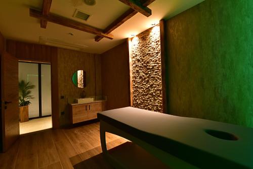 a room with a bed and a bathroom with a sink at Jasmin Elite Residence & SPA in Gümbet