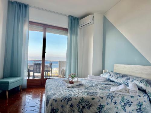 a bedroom with a bed with a view of the ocean at Special Home VISTA MARE e Parcheggio privato in Sanremo