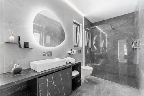 a bathroom with a sink and a toilet and a shower at Villa Panorama in Buzet