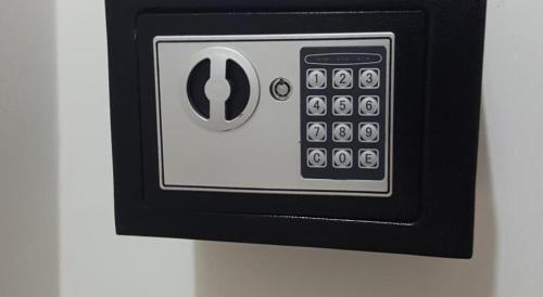 a black and white remote control on a wall at Ondo House in Nungwi