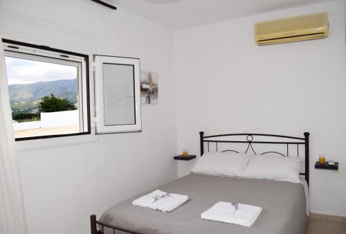 a bedroom with a bed with two towels on it at Granny's house in Georgioupolis