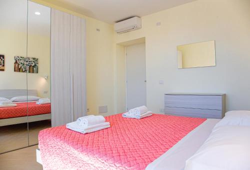 a bedroom with two beds and a mirror at Casa Corallina, wi-fi air-con IUN Q7749 in Cala Gonone