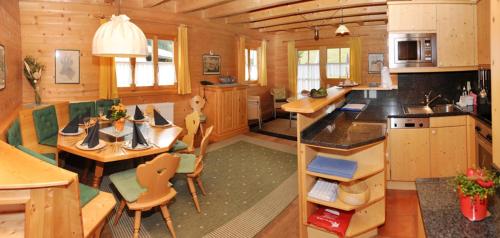 a kitchen and living room with a table and chairs at Brücklmeier Ferienwohnungen in Gargellen