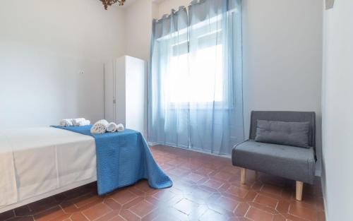 a bedroom with a bed and a chair at Villa Dell'Arco - Sea View, Private Pool & AirCo in SantʼElpidio a Mare