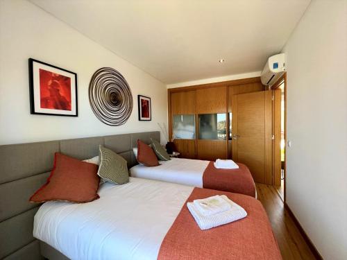 two beds in a hotel room with two bedsvisor at Albufeira Deluxe Residence With Pool by Homing in Albufeira