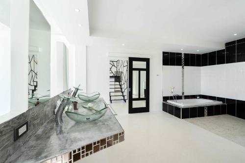 a bathroom with a sink and a bath tub at Villa Best View Samui managed by Villa For You in Koh Samui 