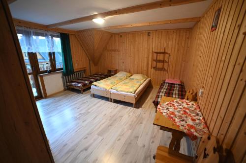 a room with two beds and a couch in it at U SKUPNIÓW Gliczarów Górny in Biały Dunajec