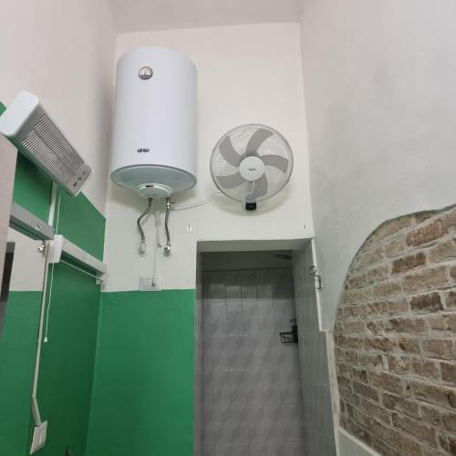 a bathroom with a fan and a walk in shower at Monolocale Studio Flat in Perugia