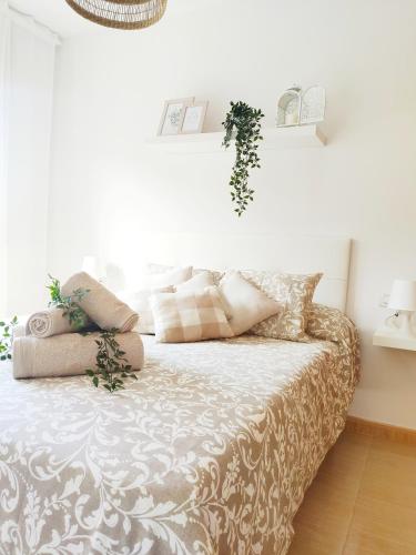 a bedroom with a bed with pillows on it at Almar Carril in Vilagarcia de Arousa
