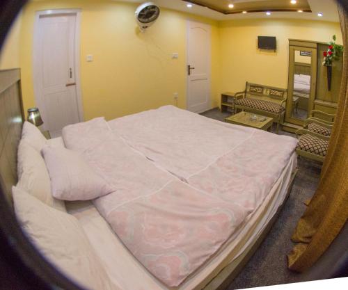 a bedroom with a large bed in a room at Ringachan Guest House & Restaurant in Skardu