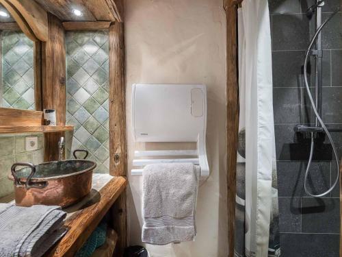 a bathroom with a shower and a sink and a tub at Chalet 6 chambres avec jacuzzi et sauna, proche télécabine et navette gratuite, Méribel Raffort - FR-1-566-8 in Les Allues